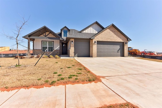 view of front of house featuring board and batten siding, brick siding, a garage, and driveway