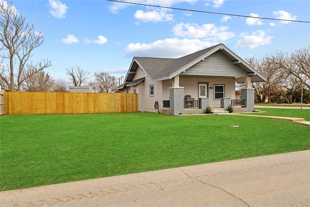 106 N Dewey St, Corn, OK 73024 - view of front of house with covered porch, fence, a front lawn, and brick siding