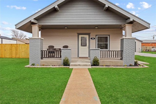 106 N Dewey St, Corn, OK 73024 - view of front facade with fence, a front yard, and a porch