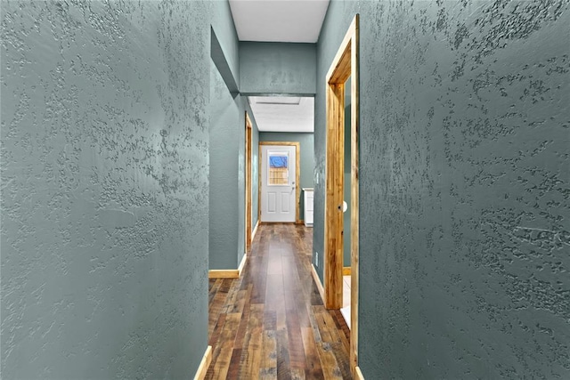 106 N Dewey St, Corn, OK 73024 - corridor featuring a textured wall, baseboards, and wood finished floors