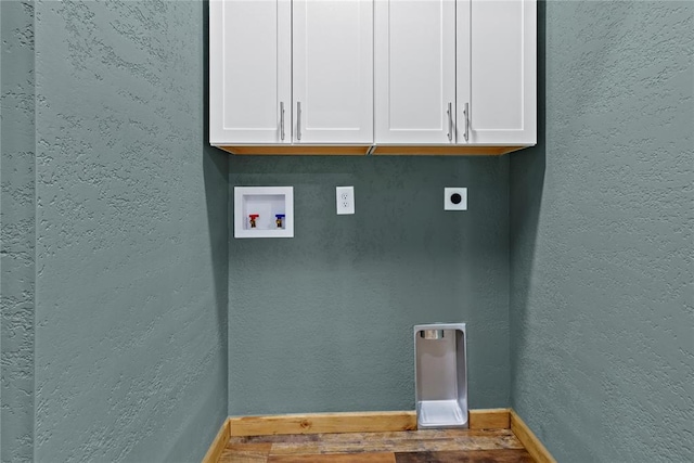 106 N Dewey St, Corn, OK 73024 - laundry area featuring hookup for a washing machine, baseboards, hookup for an electric dryer, cabinet space, and a textured wall