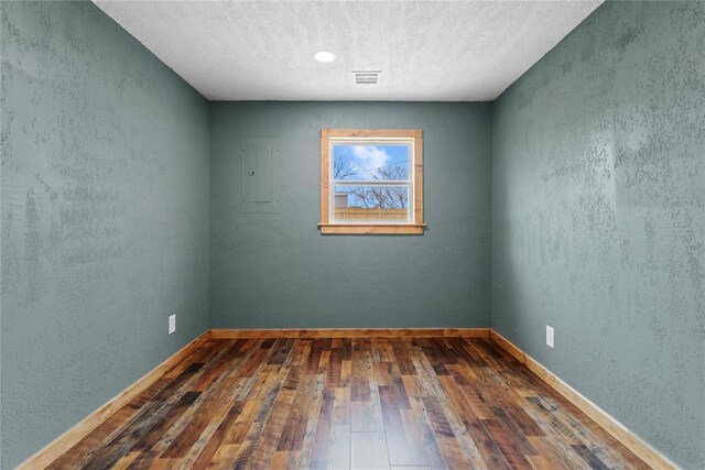 106 N Dewey St, Corn, OK 73024 - empty room with baseboards, visible vents, a textured ceiling, and wood-type flooring