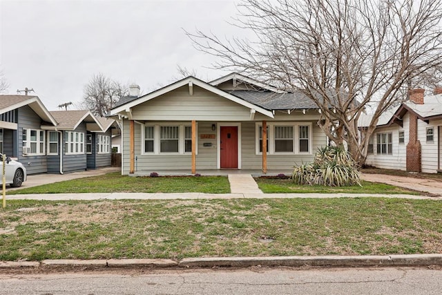 bungalow-style home featuring a front lawn