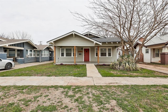 bungalow-style house featuring a front yard and covered porch