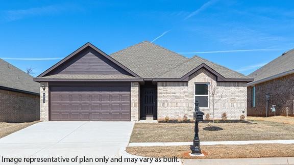 view of front of property with a garage, driveway, and brick siding