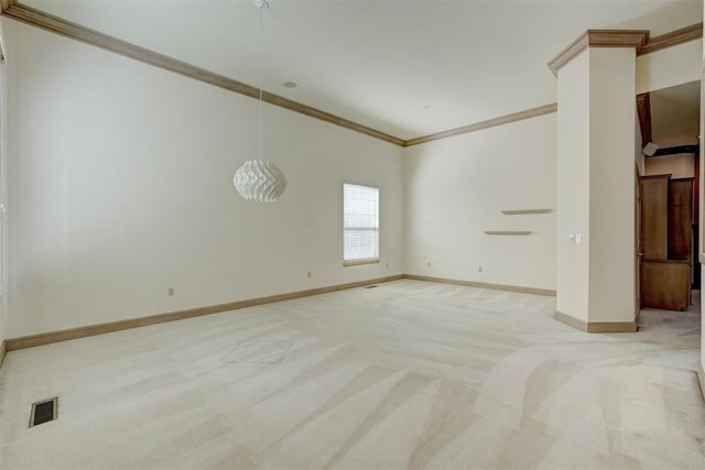 empty room with crown molding, light colored carpet, visible vents, and baseboards