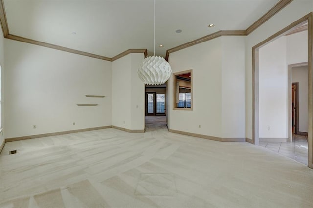 spare room featuring light carpet, crown molding, visible vents, and baseboards