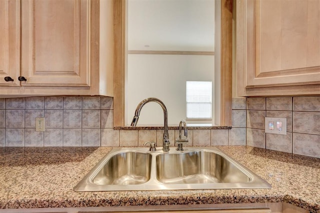 interior details with ornamental molding, light brown cabinetry, tasteful backsplash, and a sink