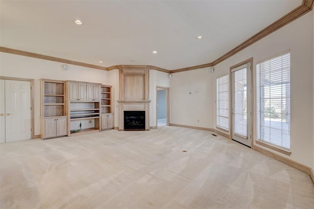 unfurnished living room with light carpet, baseboards, ornamental molding, a fireplace, and recessed lighting