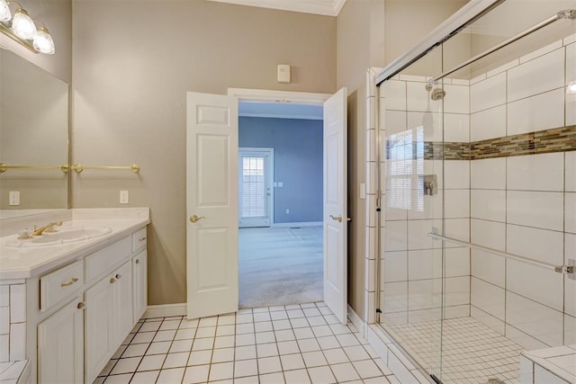 bathroom with baseboards, ornamental molding, tile patterned flooring, vanity, and a shower stall