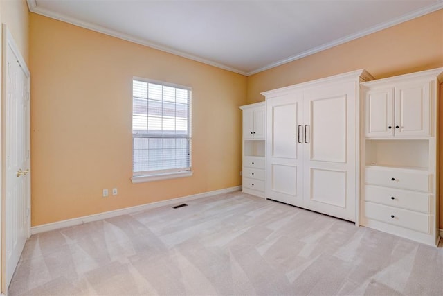 unfurnished bedroom featuring ornamental molding, light carpet, and visible vents