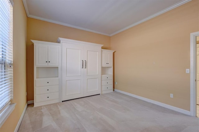 unfurnished bedroom with ornamental molding, light carpet, and baseboards