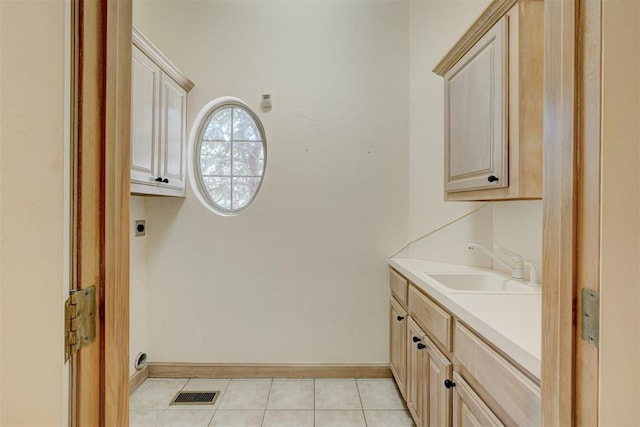 laundry room featuring cabinet space, visible vents, hookup for an electric dryer, a sink, and baseboards