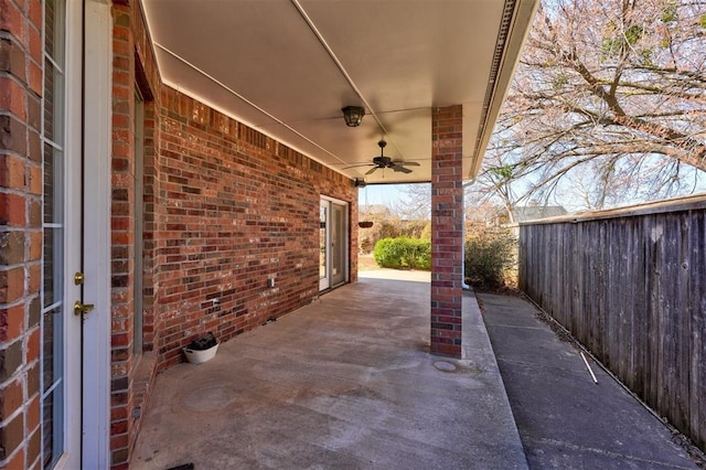 view of patio featuring ceiling fan and fence