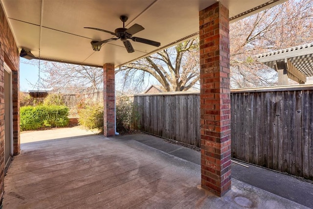 view of patio / terrace with ceiling fan and fence