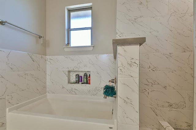 bathroom featuring a bathing tub and walk in shower