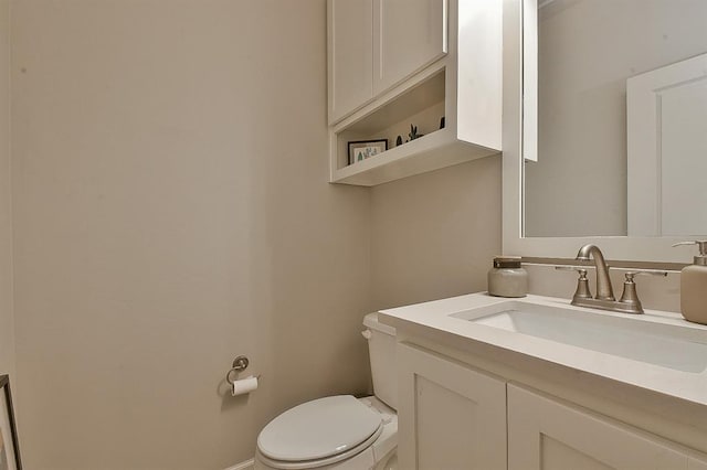 bathroom with toilet and vanity