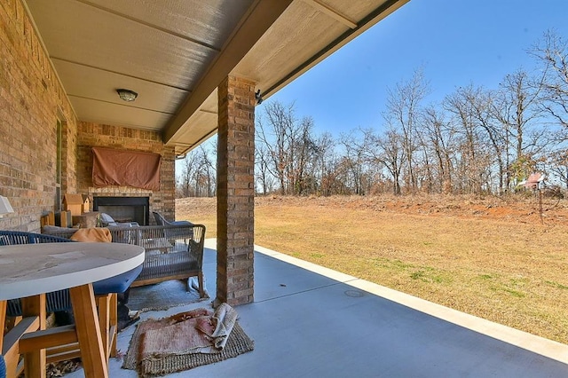 view of patio / terrace featuring a large fireplace