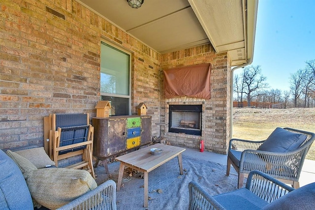 view of patio featuring an outdoor brick fireplace