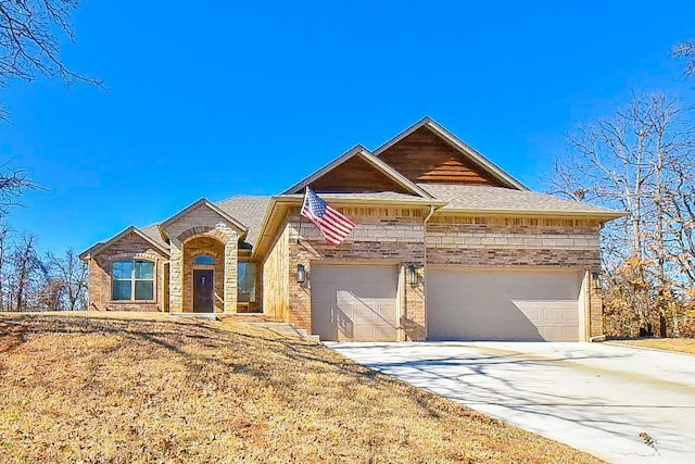 view of front of property featuring a garage, driveway, and brick siding