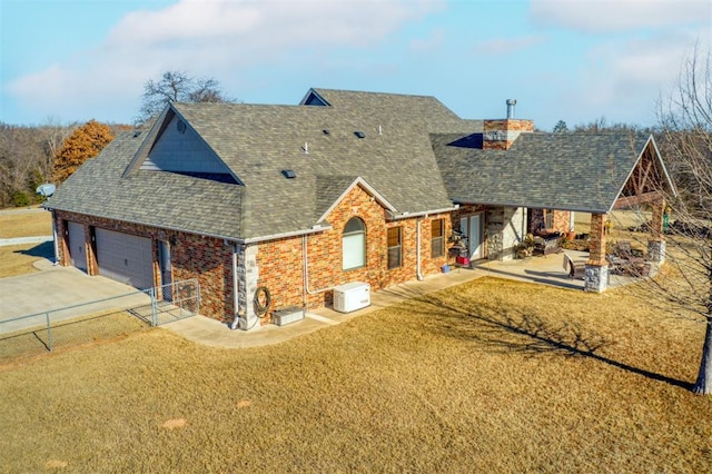 view of front facade featuring concrete driveway, brick siding, a chimney, and roof with shingles