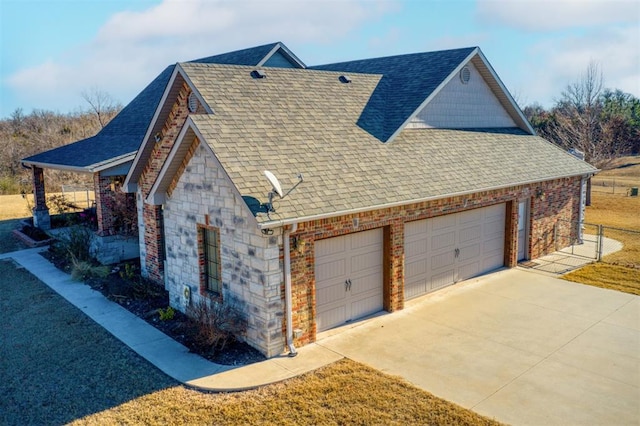 view of property exterior with roof with shingles, brick siding, a garage, stone siding, and driveway