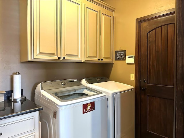 washroom featuring cabinet space and washer and dryer