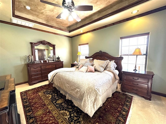 bedroom with light carpet, visible vents, and a tray ceiling