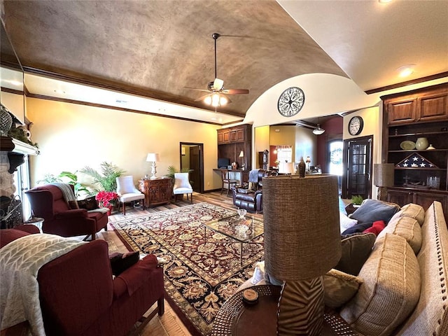 living room featuring baseboards, a ceiling fan, wood-type flooring, vaulted ceiling, and a fireplace