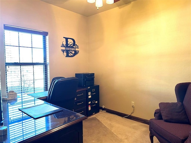 office with baseboards and light colored carpet