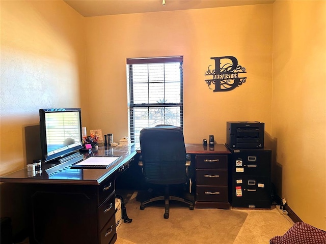 home office featuring light carpet and baseboards