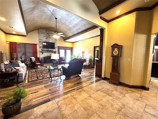 living area with visible vents, baseboards, a ceiling fan, vaulted ceiling, and a fireplace