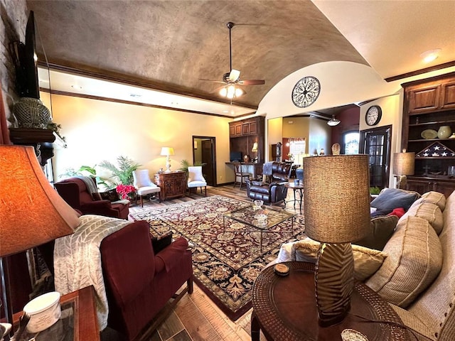 living area featuring lofted ceiling, baseboards, ceiling fan, and hardwood / wood-style floors