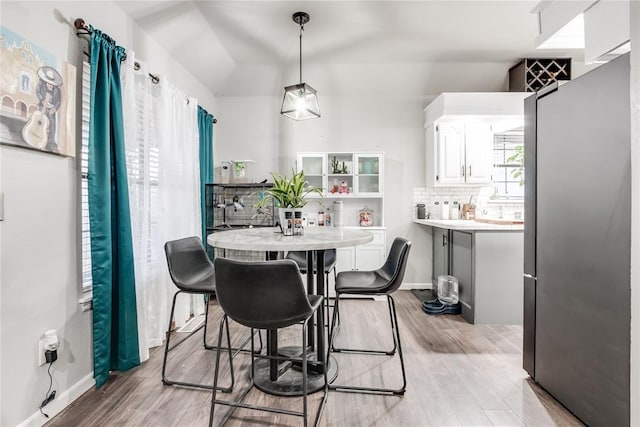 dining room with light wood-type flooring and baseboards