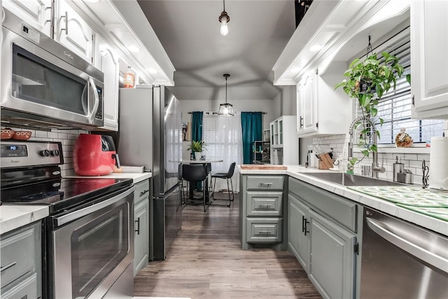 kitchen with white cabinetry, appliances with stainless steel finishes, gray cabinets, and light countertops