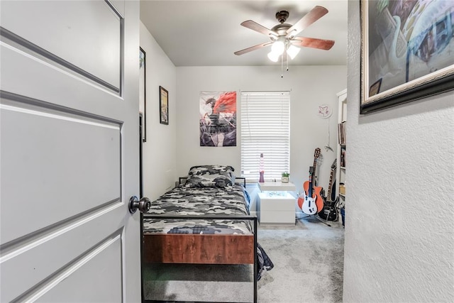 bedroom with a ceiling fan and carpet flooring