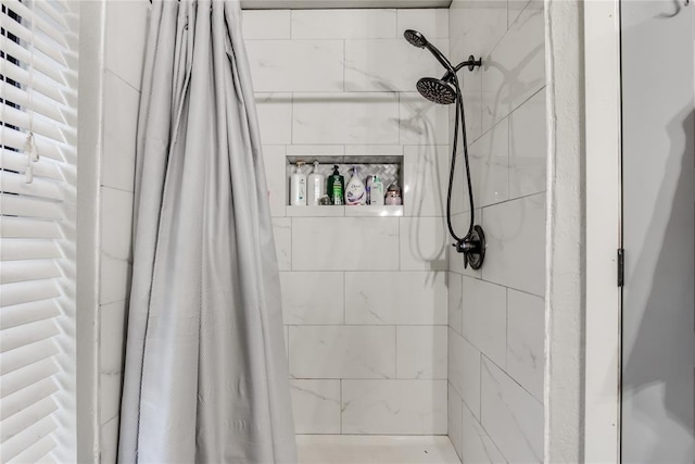 bathroom with tiled shower