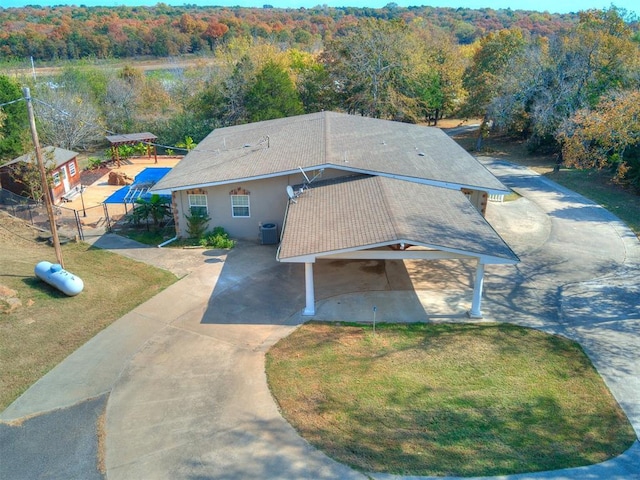 drone / aerial view with a wooded view