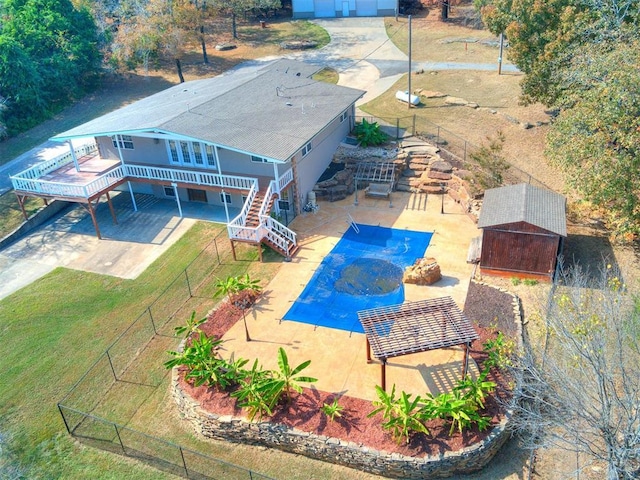 view of pool with stairs, a patio, a deck, and a lawn