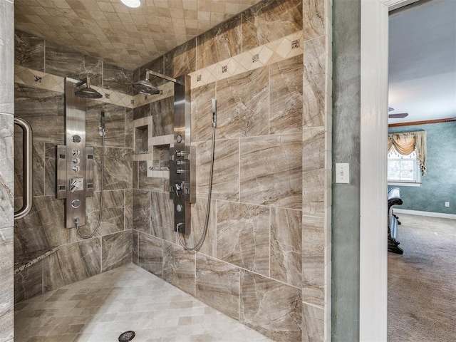 full bathroom featuring ornamental molding and a tile shower