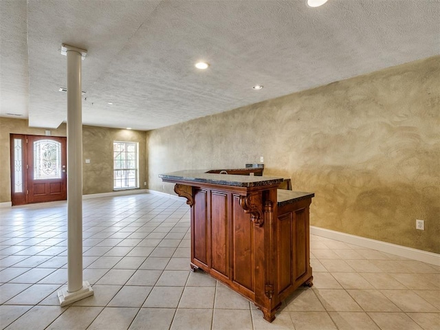 kitchen with recessed lighting, baseboards, ornate columns, and light tile patterned floors