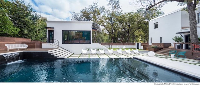 view of swimming pool featuring a patio, fence, and stairway