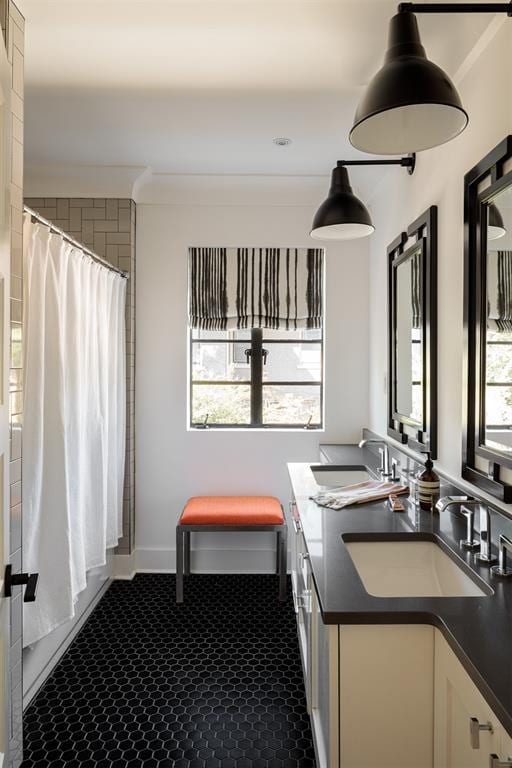 full bathroom with double vanity and a shower with shower curtain
