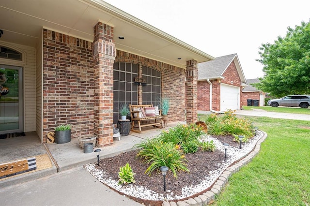 view of patio / terrace with an attached garage and concrete driveway