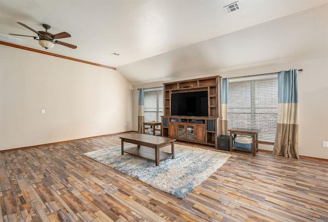 unfurnished living room featuring lofted ceiling, wood finished floors, visible vents, and baseboards