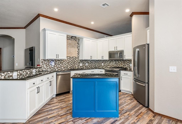 kitchen with white cabinetry, visible vents, appliances with stainless steel finishes, and wood finished floors