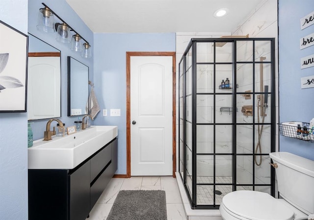 bathroom featuring toilet, recessed lighting, vanity, marble finish floor, and a shower stall