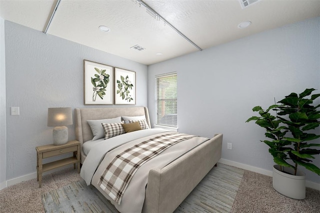 bedroom with baseboards and visible vents