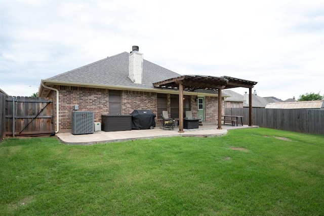 rear view of house with a fenced backyard, central AC unit, a pergola, and a patio