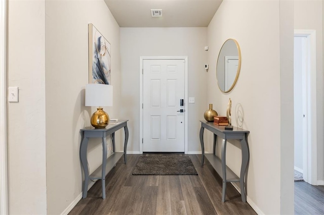 entrance foyer with baseboards, visible vents, and dark wood finished floors